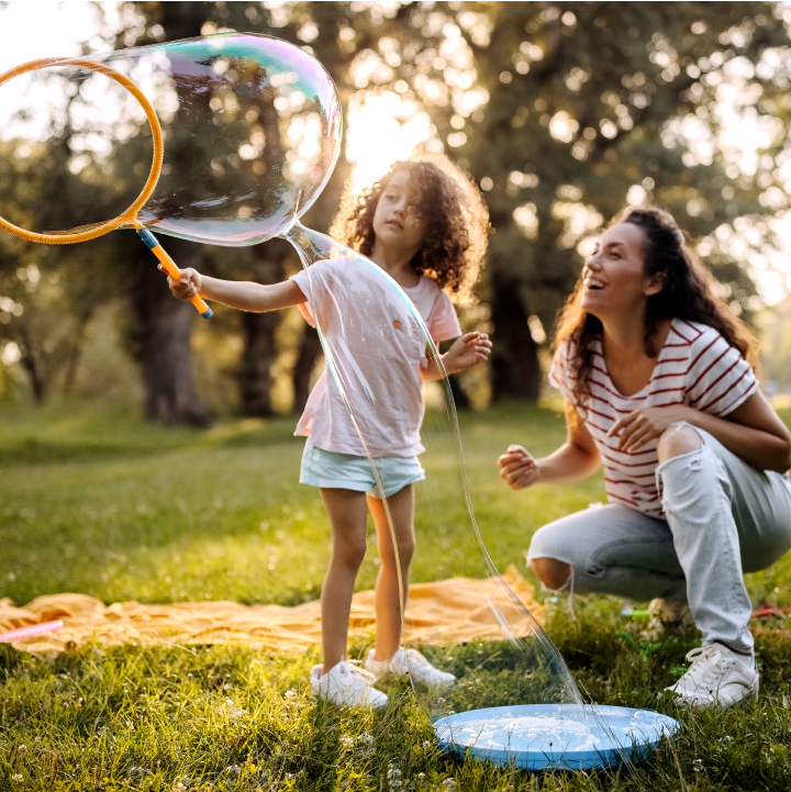 Mason - mother and daughter blowing bubbles